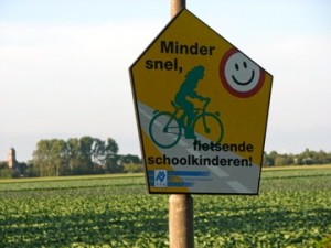 Translation: Drive slowly, schoolchildren riding bikes.