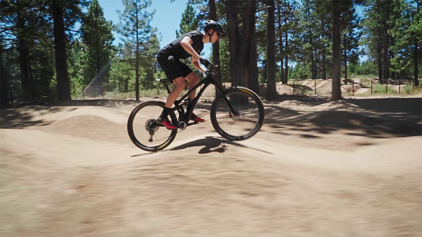 Nate is riding a pump track, but using the mountain biking skills row and anti-row.