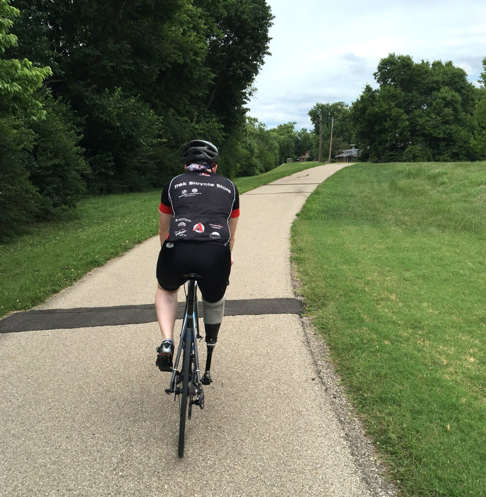 Austin riding his bike after his amputation