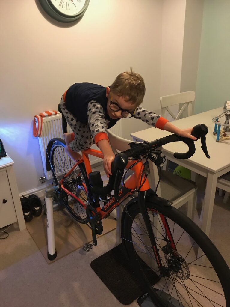 Rob's son, Jack, sitting on the turbo he used for training for bikepacking.