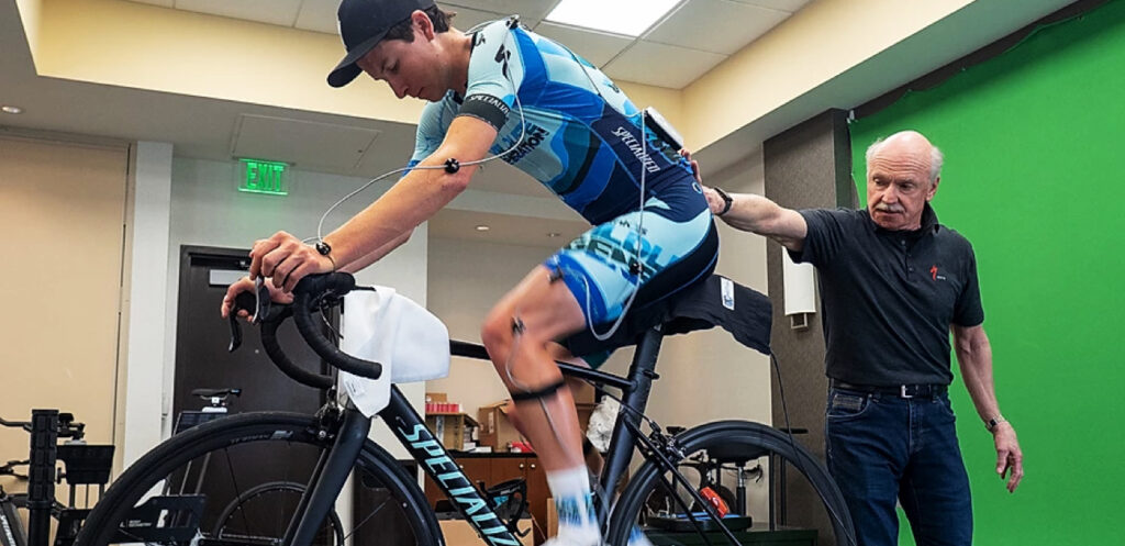 Dr. Andy Pruitt conducts a bike fit with a cyclist.