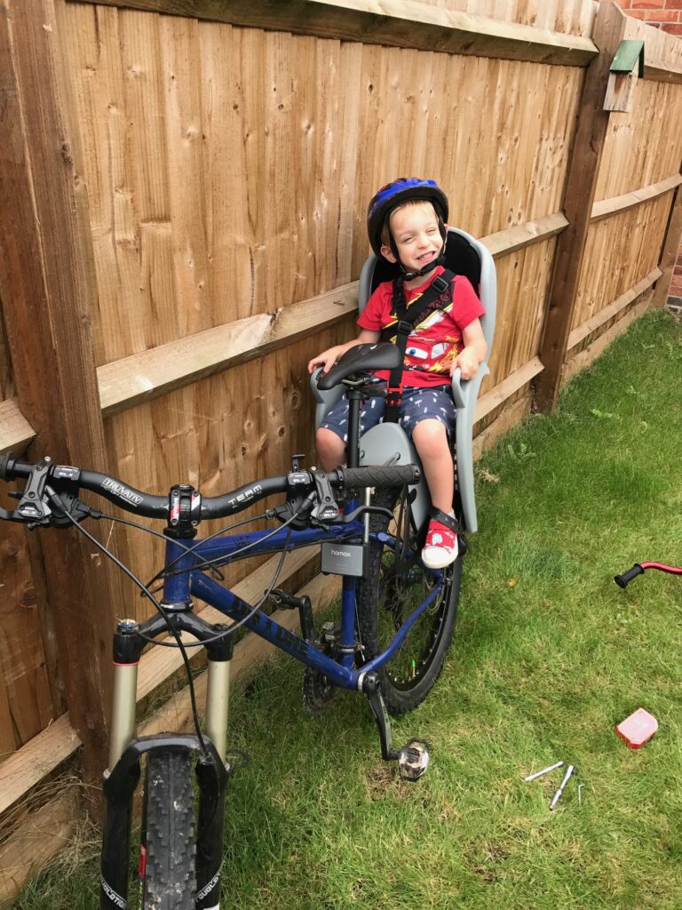 Jack sits on the bike for a ride in which Rob learned that needed training for bikepacking.