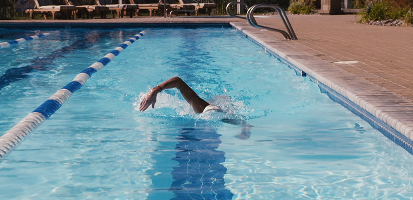 This is a triathlon completing a triathlon swim workout in a pool.