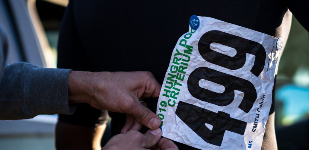 An athlete pins a number on during their first season racing.