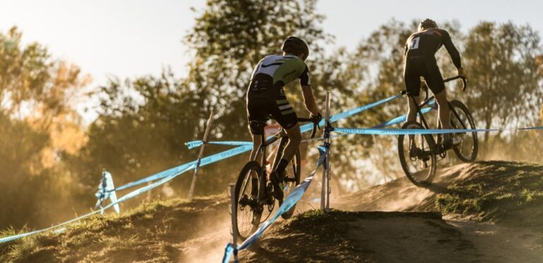 A cyclocross racer rides up a hill